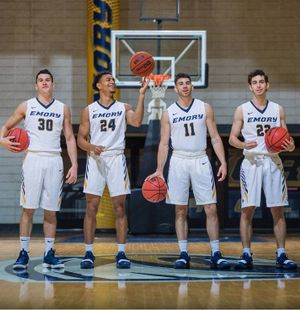 Four athletes on a basketball court.