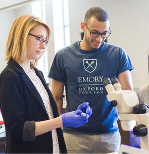 A professor guides a student in research.